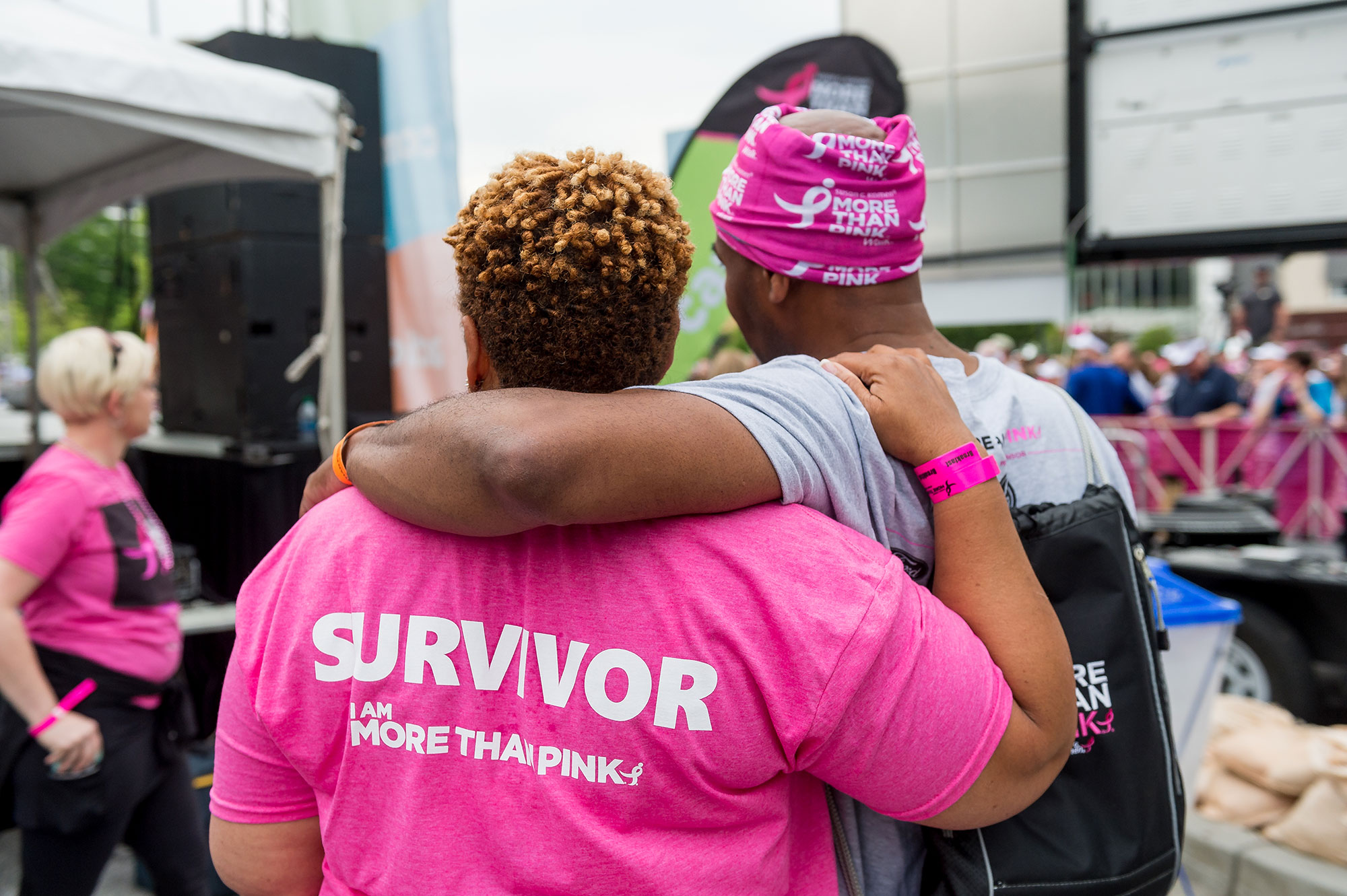 a survivor and supporter with arms around each other